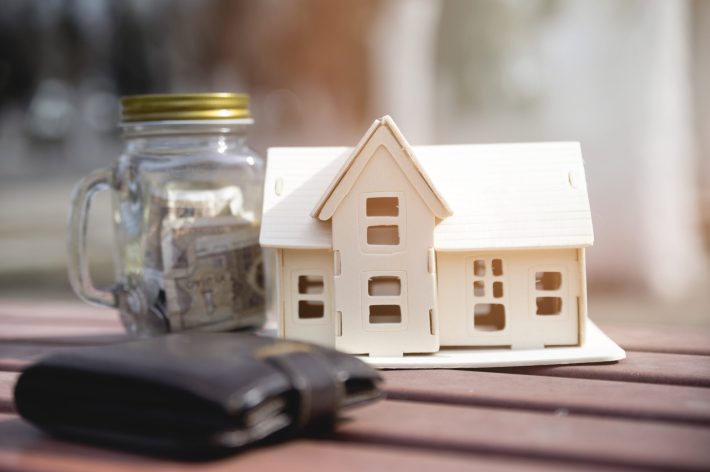 Oregon home with financial charts and rising equity graph representing smart home equity optimization strategies